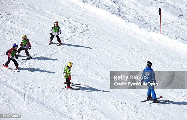 Little children follow their teacher in a skiing lesson on March 19, 2010 in Lermoos, Tyrol, Austria.