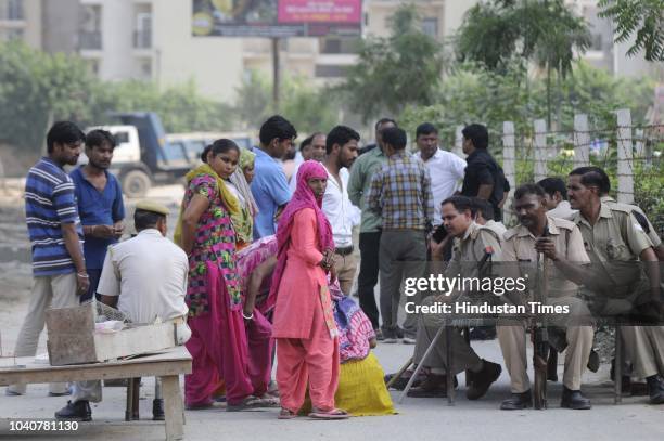 Police personnel seen at the site as Greater Noida authorities demolish the illegal structures on a land located near Shahberi village, on September...