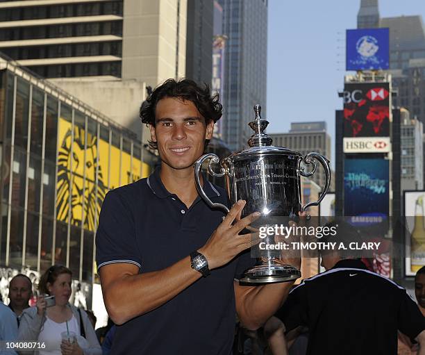 Rafael Nadal from Spain poses with his trophy in Times Square September 14 the morning after winning the Men's Singles Final at the US Open 2010 at...