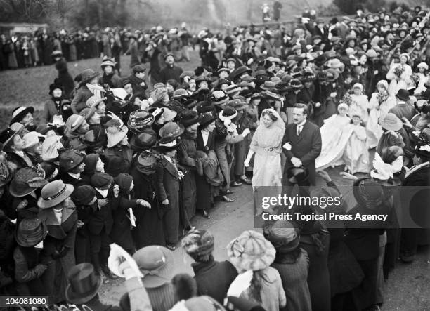 Crowds surround Lady Adelaide Margaret Spencer and Sir Sidney Cornwallis Peel as they make their way to their car after their wedding at Great...