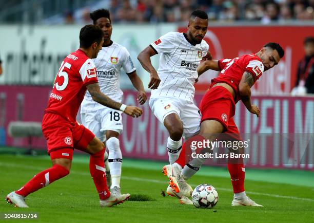 Ayhan Kaan of Duesseldorf and Isaac Kiese Thelin of Leverkusen battle for the ball during the Bundesliga match between Fortuna Duesseldorf and Bayer...