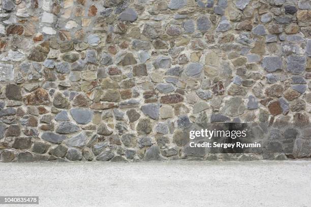 empty concrete floor and stone city wall - mur de pierres photos et images de collection