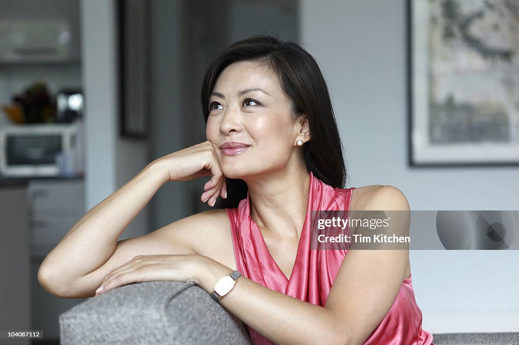 Woman relaxing at home, smiling