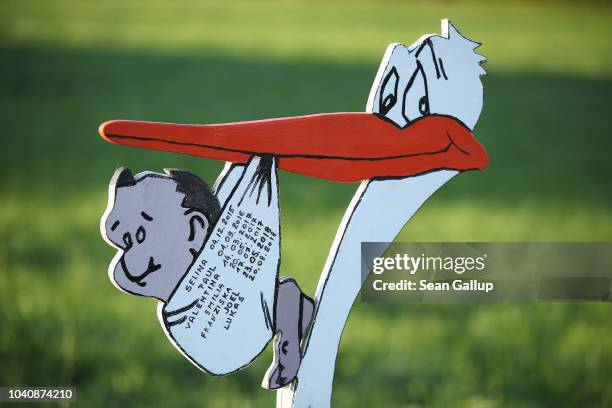 Sign showing a stork carrying a baby advertises the services of a midwife on September 21, 2018 near Laufen, Germany. Midwives in Germany serve two...