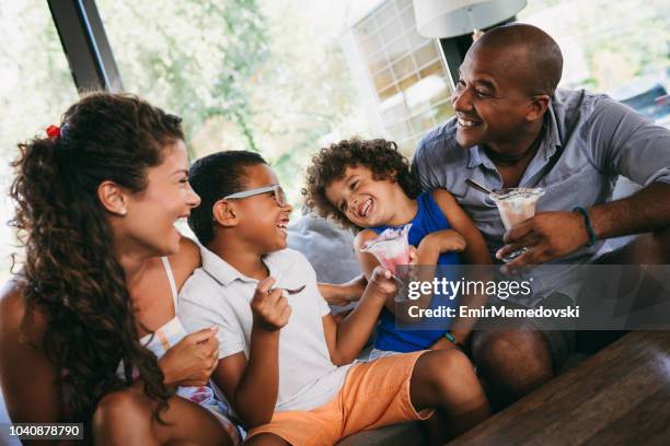 happy family spending time in cafe and eating ice cream - ice cream family stock pictures, royalty-free photos & images