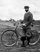 Victorian image of a man in plus fours and a boater stood besides his bike; from The Navy and Army Illustrated 1899