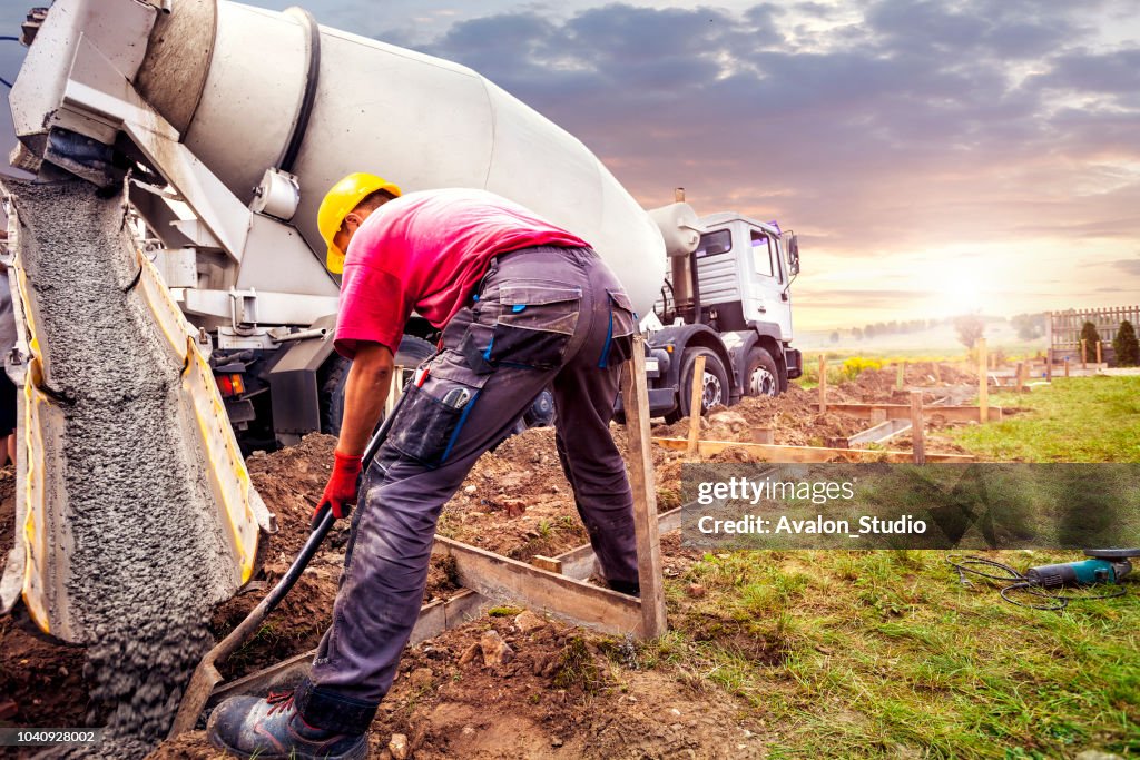 Pouring concrete to the foundations of the building