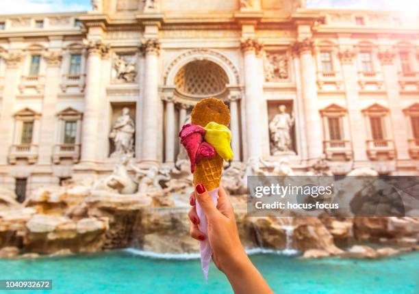 famous italian gelato at trevi fountain rome - woman ice cream stock pictures, royalty-free photos & images