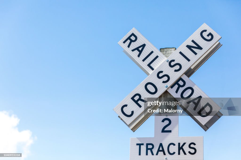 Railroad crossing sign against clear blue sky. Seattle, Washington, USA.