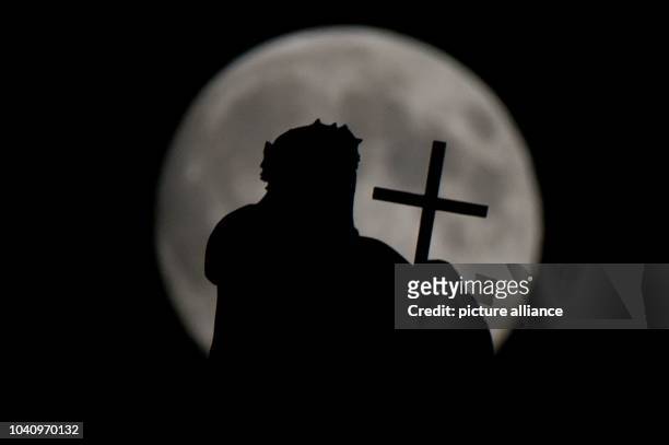The Mattielli figure Maria Magdalena de Pazzi is pictured in front of the rising moon on the Catholic Church of the Royal Court of Saxony in Dresden,...