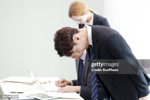 business people taking bow in meeting - bowing stock pictures, royalty-free photos & images