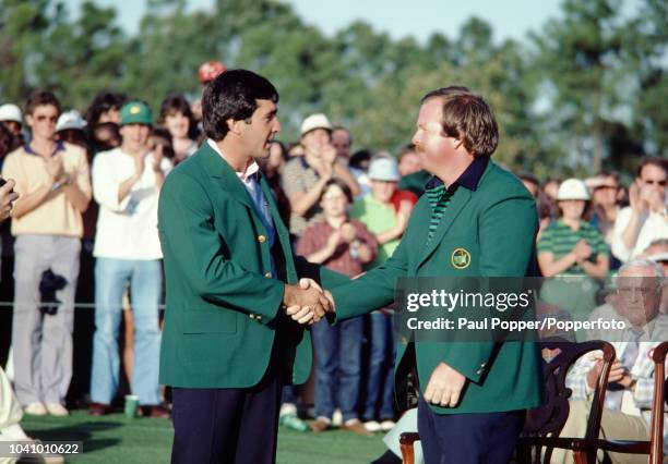 Spanish professional golfer Seve Ballesteros, wearing the green jacket, is congratulated by Craig Stadler of the United States after finishing in...