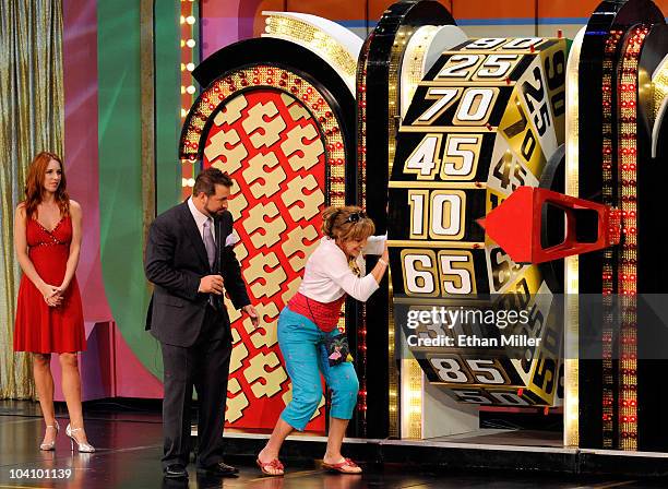 Model Megan Wilson and entertainer Joey Fatone watch contestant Joan Butler of Georgia spin a wheel as Fatone hosts "The Price Is Right - Live" Stage...