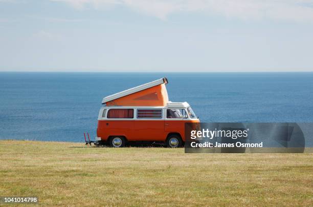classic vw camper van at coastal campsite - volkswagen stock pictures, royalty-free photos & images