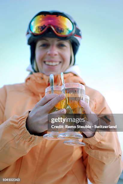 woman with drinks at apres ski in st. moritz. - apres ski stock pictures, royalty-free photos & images
