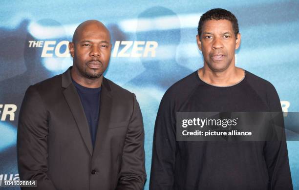 Actor and film director Antoine Fuqua and US actor Denzel Washington pose during the presentation of the film "The Equalizer" in Berlin, Germany, 16...