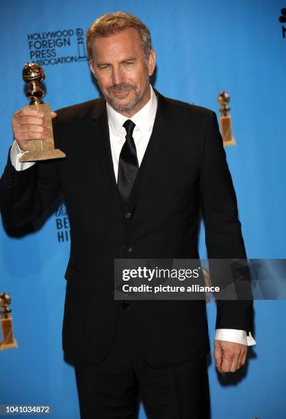 Actor Kevin Costner poses in the photo press room of the 70th Annual Golden Globe Awards presented by the Hollywood Foreign Press Association, HFPA,...