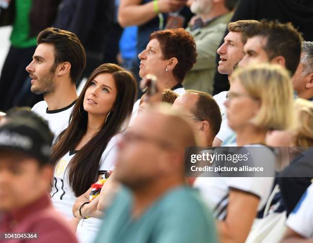 Lena , girlfriend of Germany's Julian Draxler, and Klaudia and Simon Mueller, mother and brother of Gemany's Thomas Mueller, are seen in the stands...