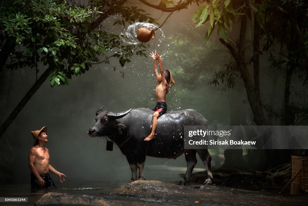 Lao father and son throw the equipment to fish