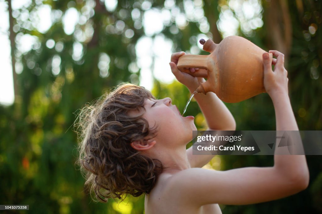 Boy drinking fresh water in " botijo"