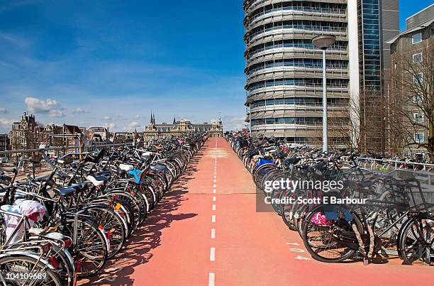 bikes parked at central station, amsterdam - amsterdam bike stock-fotos und bilder