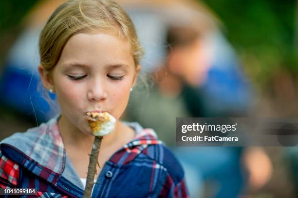 eating a marshmallow - marshmallow stock pictures, royalty-free photos & images