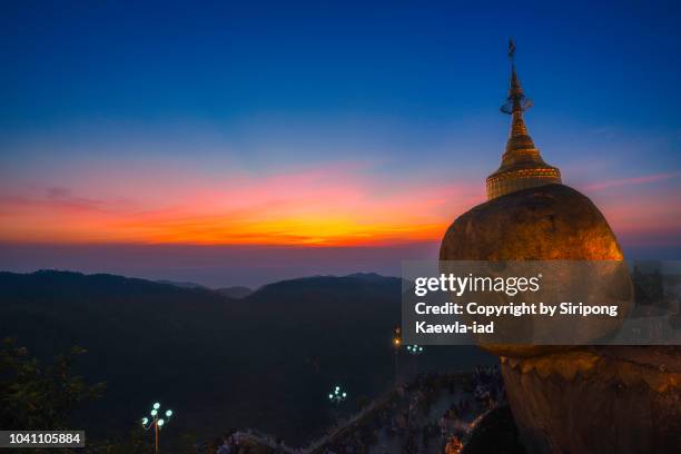 the golden rock at the kyaiktiyo pagoda at dusk. - kyaiktiyo pagoda stock pictures, royalty-free photos & images