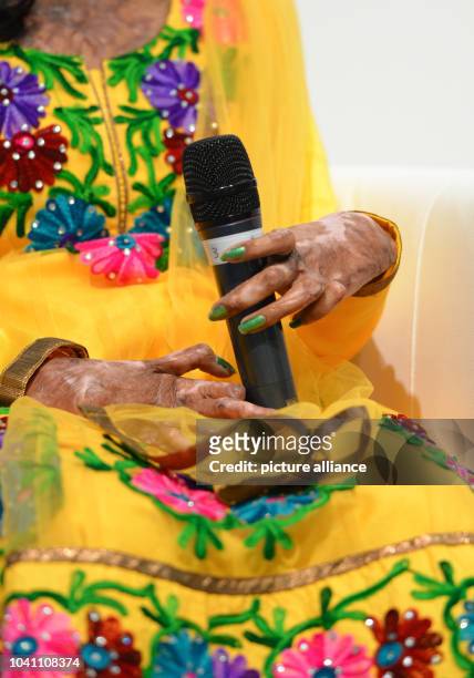 Neehari from India plays with the microphone during the presentation of the book project 'Un/Sichtbar' by photographer A.-Chr. Woehrl at the book...