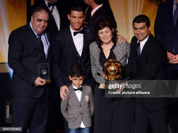 Portuguese striker Cristiano Ronaldo poses for photographers with his son Cristiano Jr., his mother Maria Dolores dos Santos Aveiro and his brother...