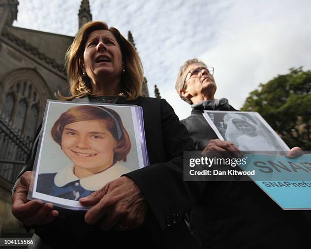 Barbara Blaine and Barbara Dorris hold pictures of them as children on the steps of St Mary's Metropolitan Cathedral on September 15, 2010 in...