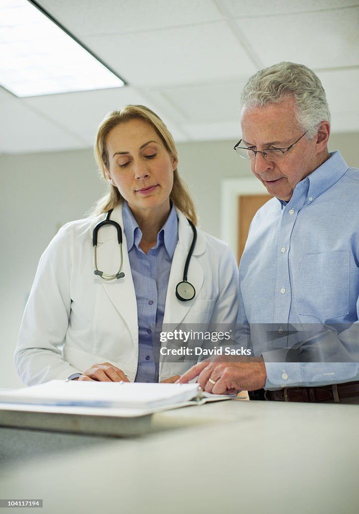 Two doctors looking at medical chart
