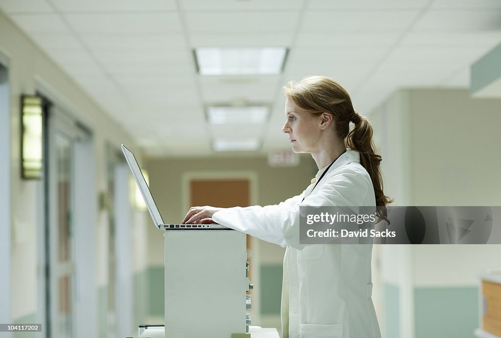 Female doctor on laptop in hospital