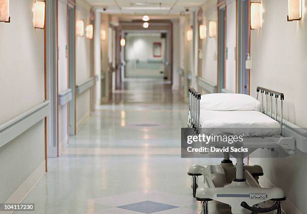 portable hospital bed in hallway - corridor stock-fotos und bilder