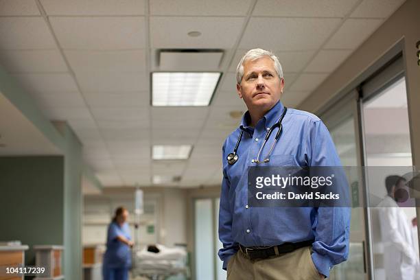 doctor standing in hospital hallway - group people thinking stock pictures, royalty-free photos & images