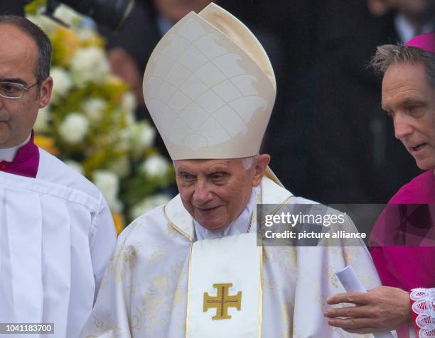 Retired Pope Benedict XVI and his Secretary Georg Gaenswein arrive for the Canonization Service at St. Peter's Square in the Vatican, 27 April 2014....