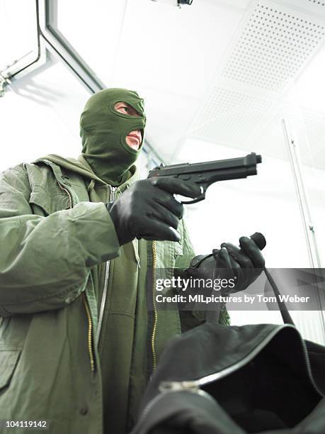 bank robber with hand gun. - bankräuber stock-fotos und bilder