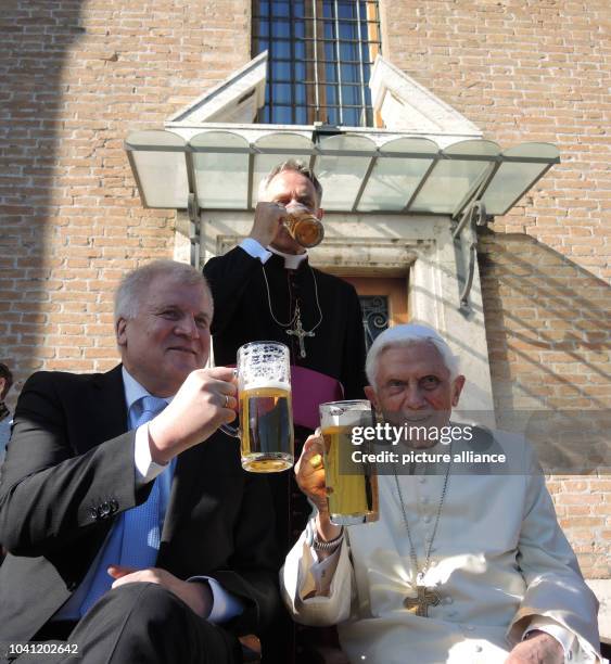 The retired Pope Benedict XVI and the premier of the state of Bavaria, Horst Seehofer , drink a glass of beer in the Vatican Garden in Vatican City,...
