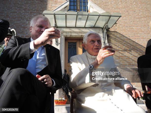 The retired Pope Benedict XVI and the premier of the state of Bavaria, Horst Seehofer , drink a glass of spirits in the Vatican Garden in Vatican...