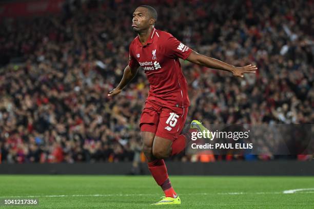 Liverpool's English striker Daniel Sturridge celebrates scoring the opening goal during the English League Cup third round football match between...