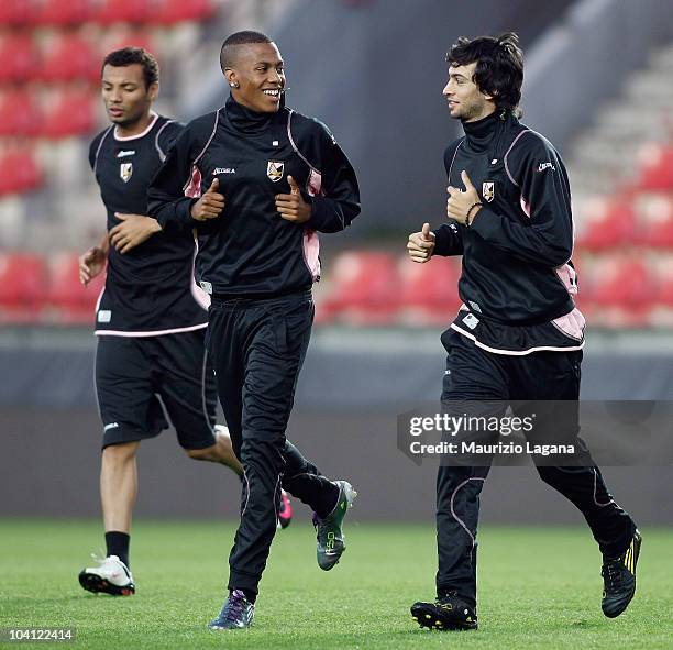 Abel Hernandez and Javier Pastore of US Citta di Palermo jog during a training session ahead of the UEFA Europa League match against Sparta Prague at...