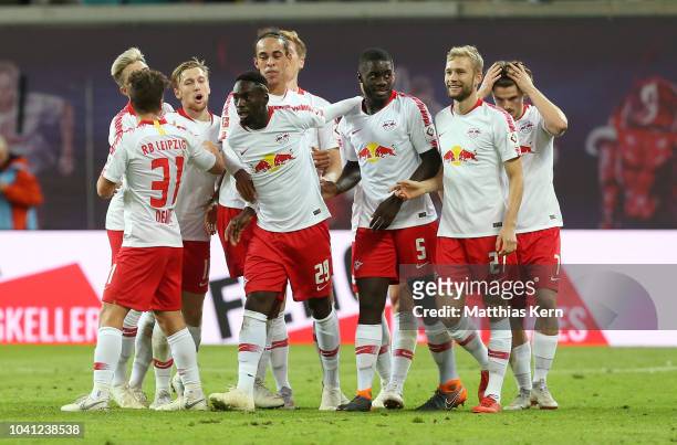 Jean Kevin Augustin of Leipzig jubilates with team ates after scoring the second goal during the Bundesliga match between RB Leipzig and VfB...