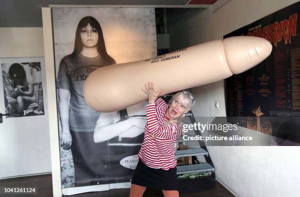 The American artist Cynthia Albritton alias Cynthia Plaster Caster poses with a huge blow up penis, in the background is an image of Frank Zappa. Her...