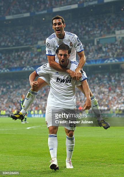 Gonzalo Higuain of Real Madrid celebrates scoring his sides second goal with his teammate Alvaro Arbeloa during the UEFA Champions League group G...