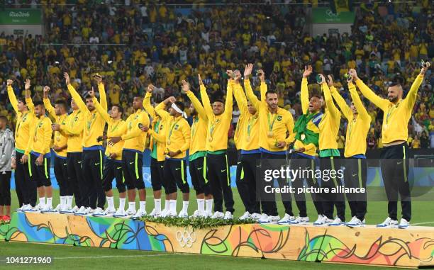 The Brazilian team celebrates on the podium during the award ceremony after winning the Men's soccer Gold Medal Match between Brazil and Germany...