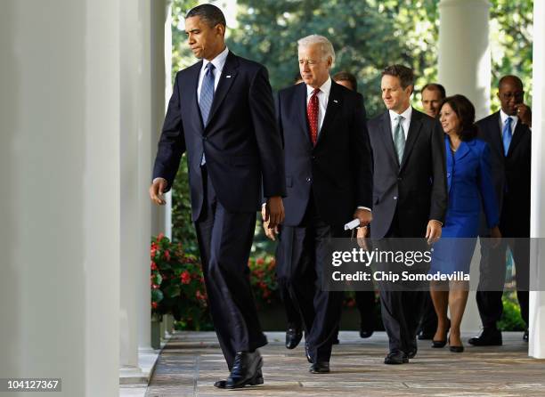 President Barack Obama walks into the Rose Garden before urging Congress to pass a bill for middle class tax cuts along with members of his cabinet...