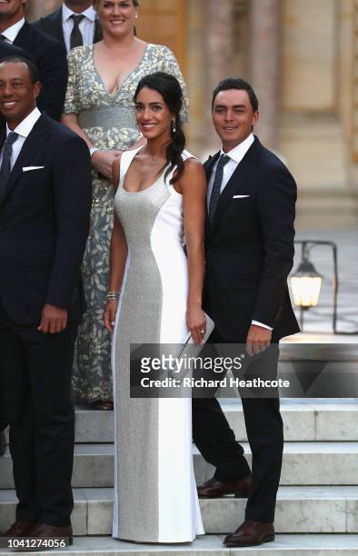 Rickie Fowler of the United States and fiance Allison Stokke pose with Team United States before the Ryder Cup gala dinner at the Palace of...