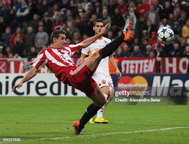 Miroslav Klose of Bayern scores the second goal as Aleandro Rosi of Roma watches him during the UEFA Champions League group E match between FC Bayern...