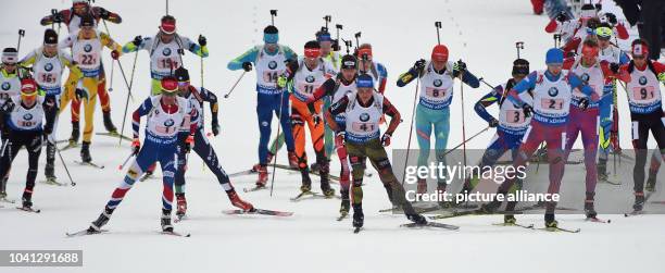 The field with Ole Einar Bjoerndalen of Norway, Erik Lesser of Germany and Maxim Tsvetkov of Russia in the first row in action during the Men«s 4x7.5...