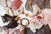 set of seasonal autumn fashion woman clothes, top view with copy space. Trendy shoes, sweater and handbag.