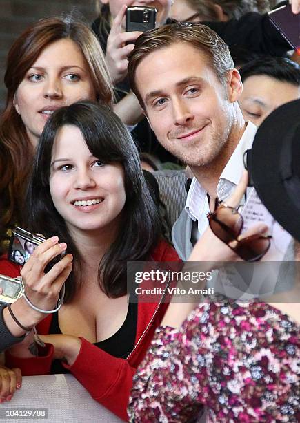 Actor Ryan Gosling poses with fans at the "Blue Valentine" Premiere during the 35th Toronto International Film Festival at Ryerson Theatre on...